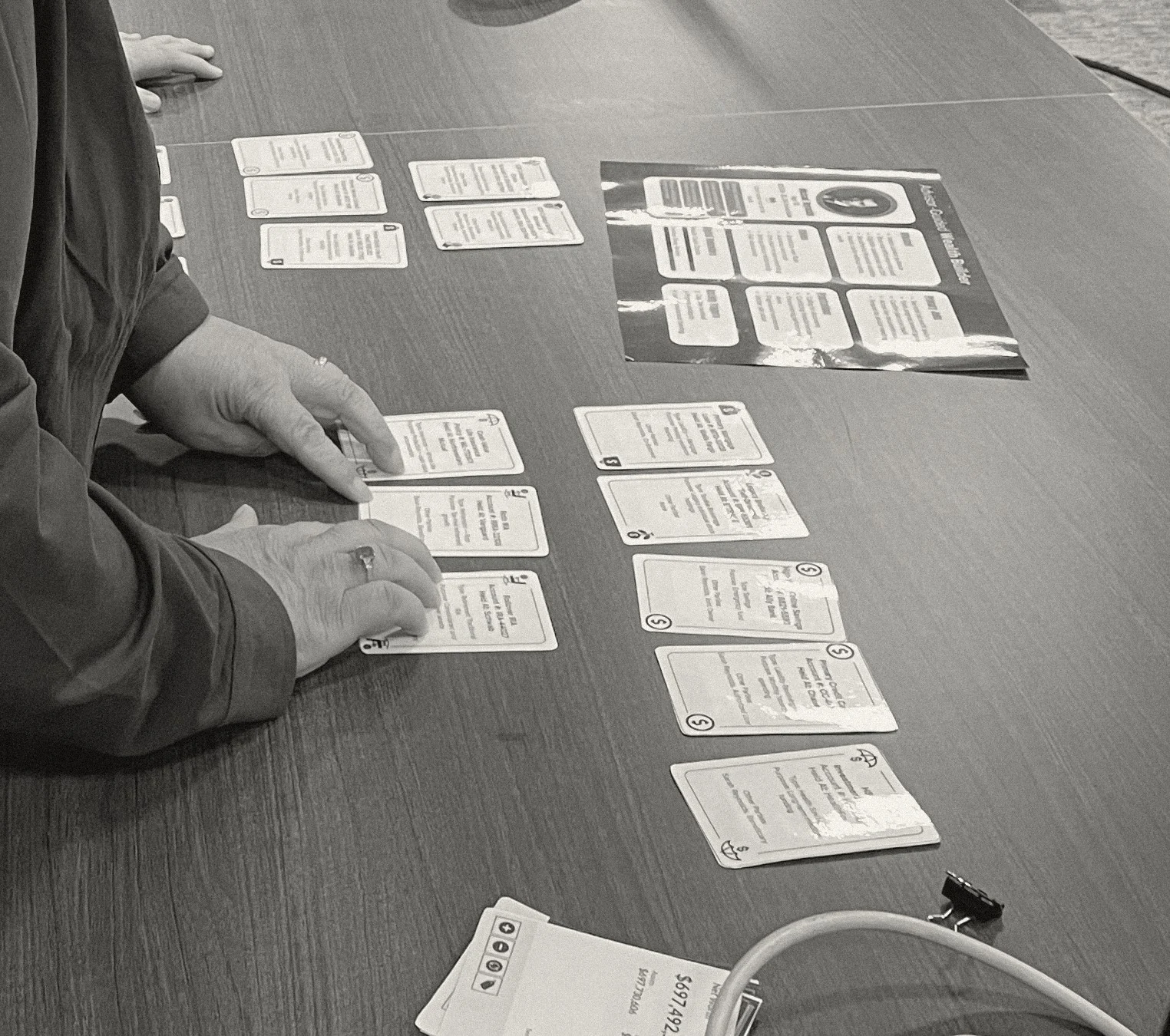 The participation game in play — role cards and budget sheets on the table